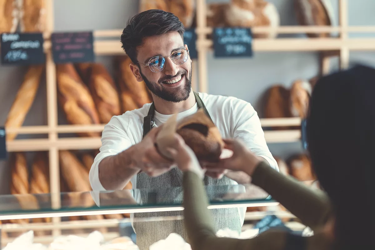 AdobeStock_BakerHandingBread.jpg